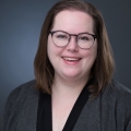 Picture of Sophie McNeil Wolf, wearing glasses smiling